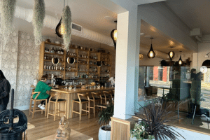 Inside of the restaurant Enso with light wood chairs and white walls, decorated in a wabi sabi style.