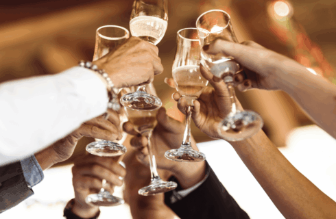 People of diverse backgrounds clinking champagne flutes in a toast, celebrating together.