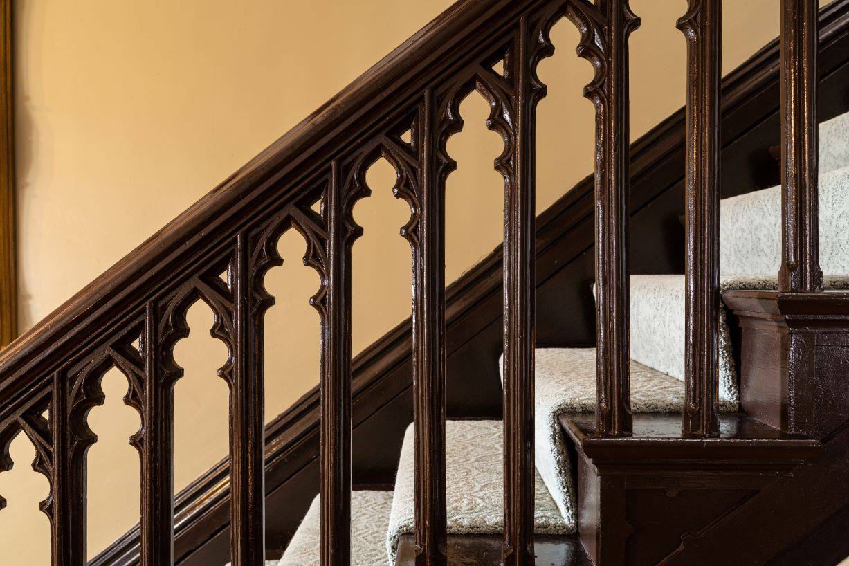 Close up of the rails of a staircase in a gothic style. 