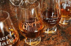 Close up view of many glasses filled with bourbon