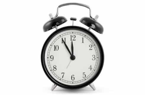 Old time alarm clock with ringer bells on top with white background